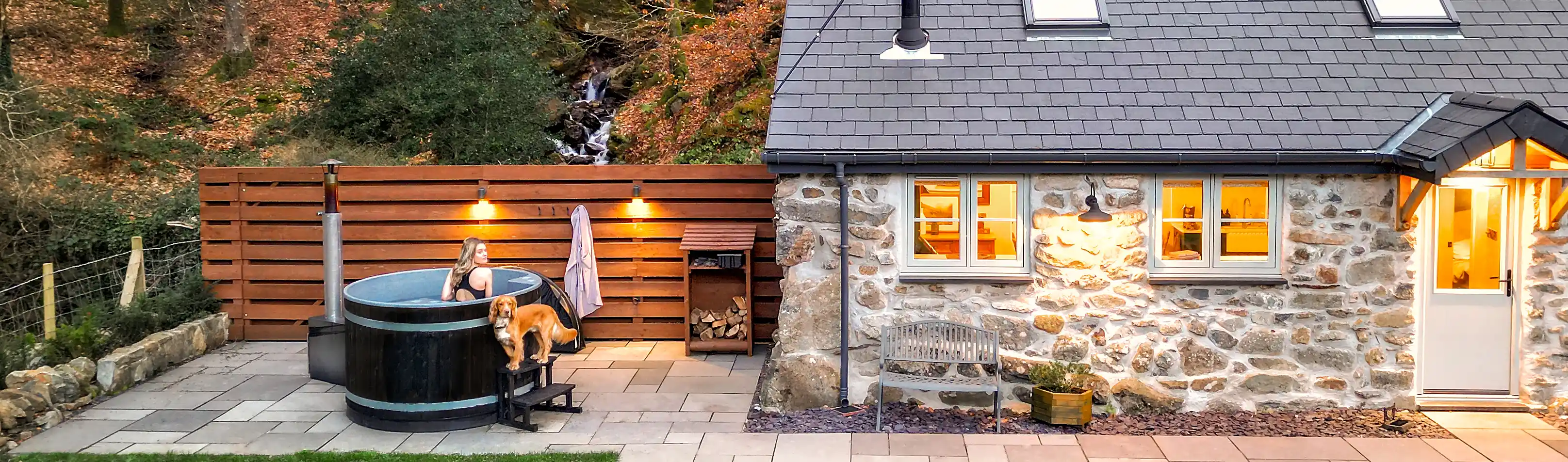 Guest relaxing in the hot tub at Coed Llydan