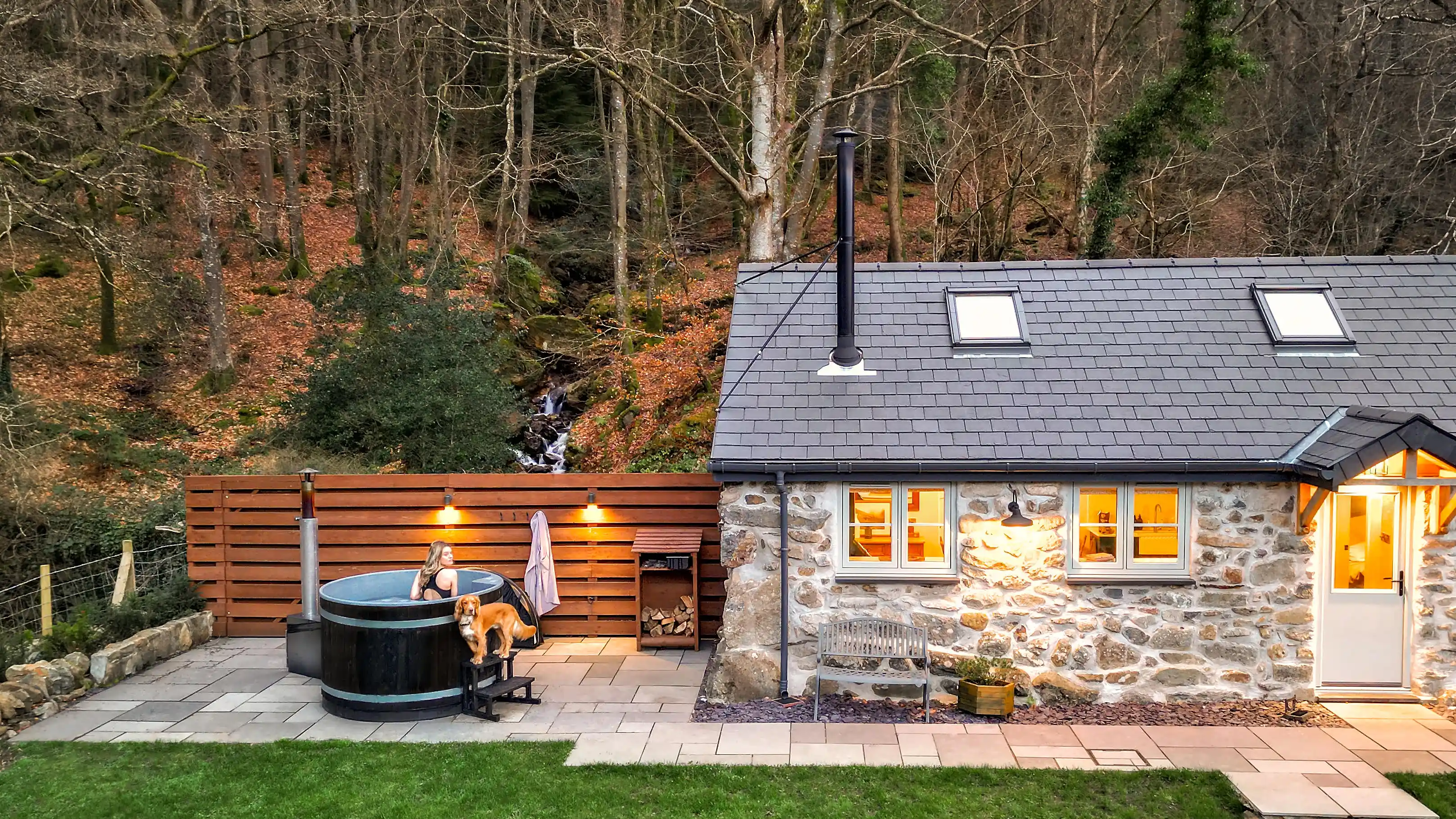 A guest in the hot tub at Coed Llydan