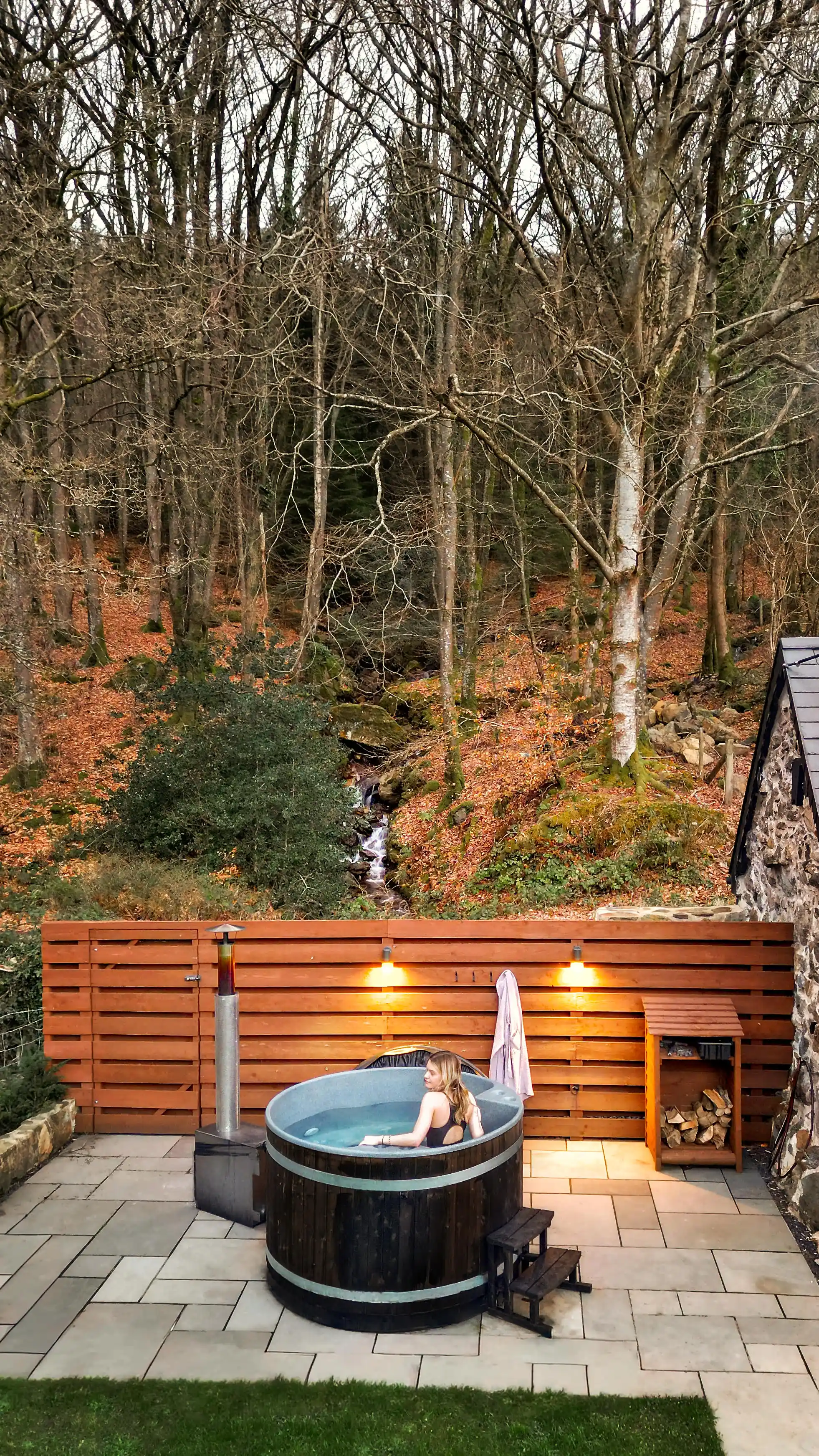 A guest in the hot tub at Coed Llydan